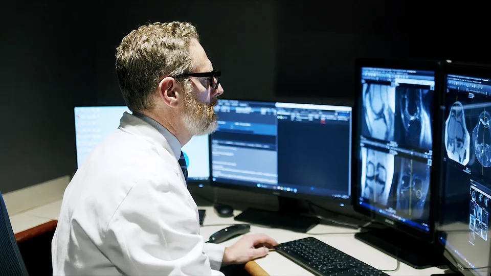 Dr. Timothy Deyer reviews MRI studies at a reading station at East River Medical Imaging