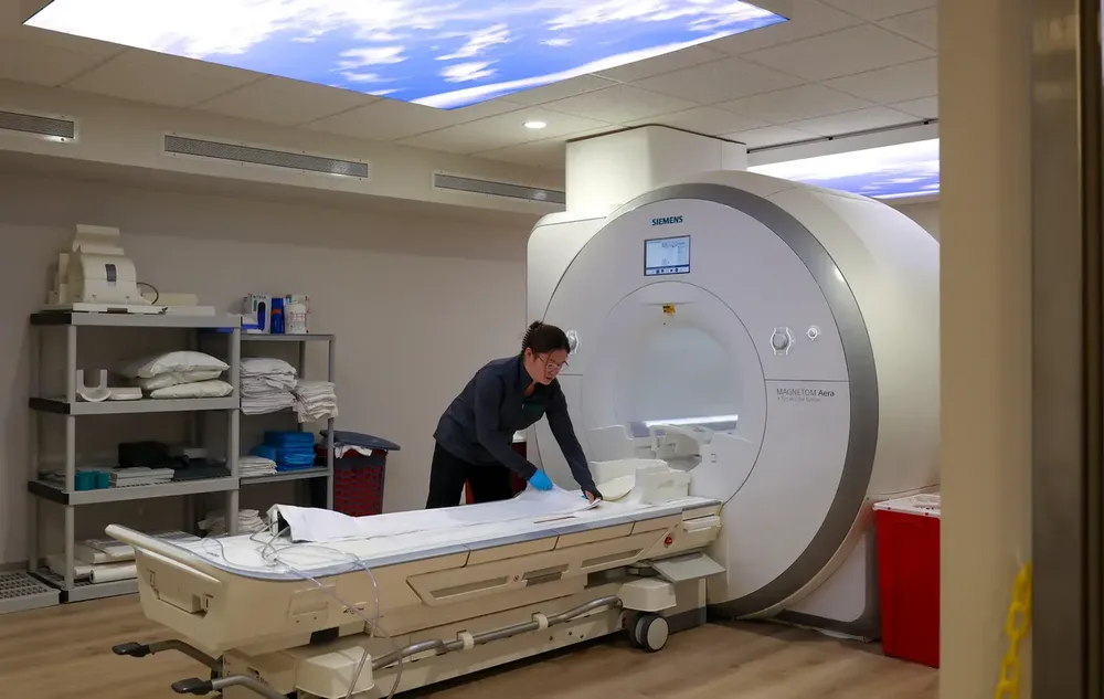 A technologist prepares the table of a Siemens MAGNETOM Aera MRI at an Invision Sally Jobe imaging center